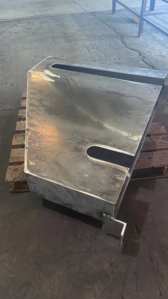 Polished stainless steel cover panel with slotted handle cutouts